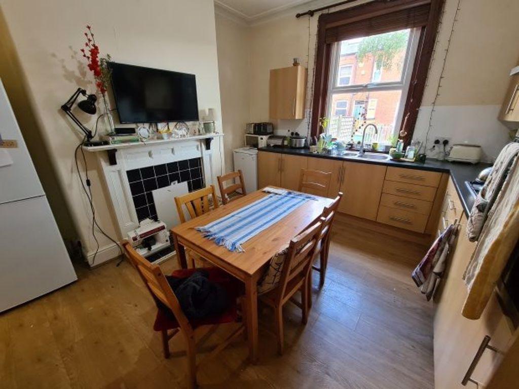 A bright and cozy kitchen with natural light co...