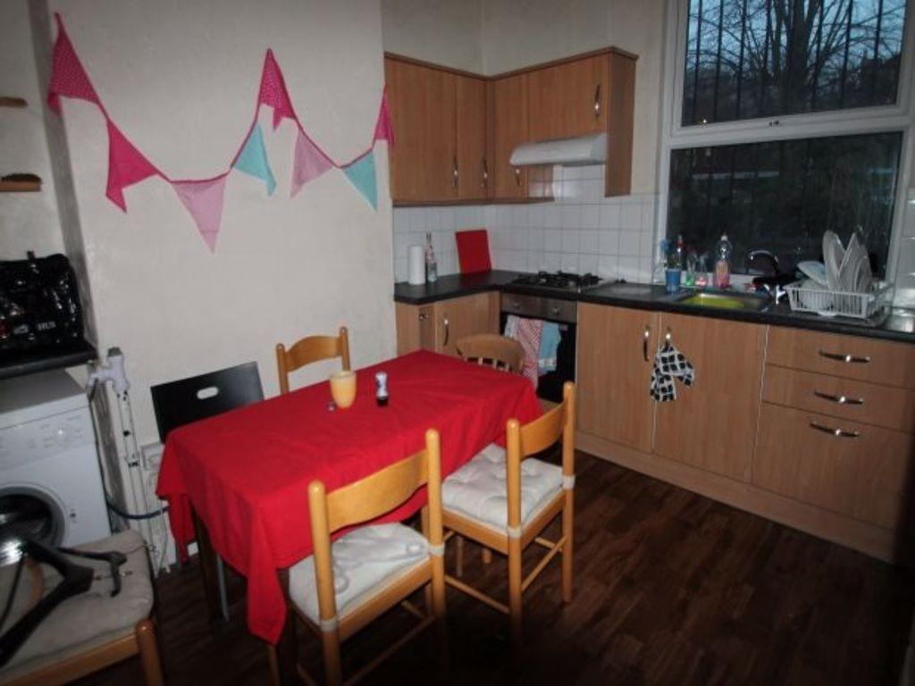 A well-maintained kitchen with wooden cabinets,...