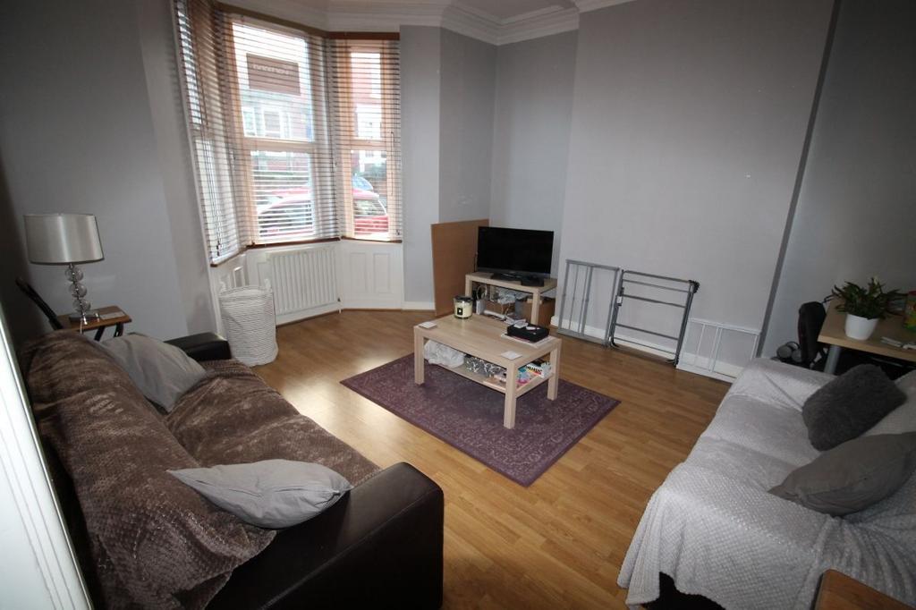 A well-lit, comfortably arranged living room fe...