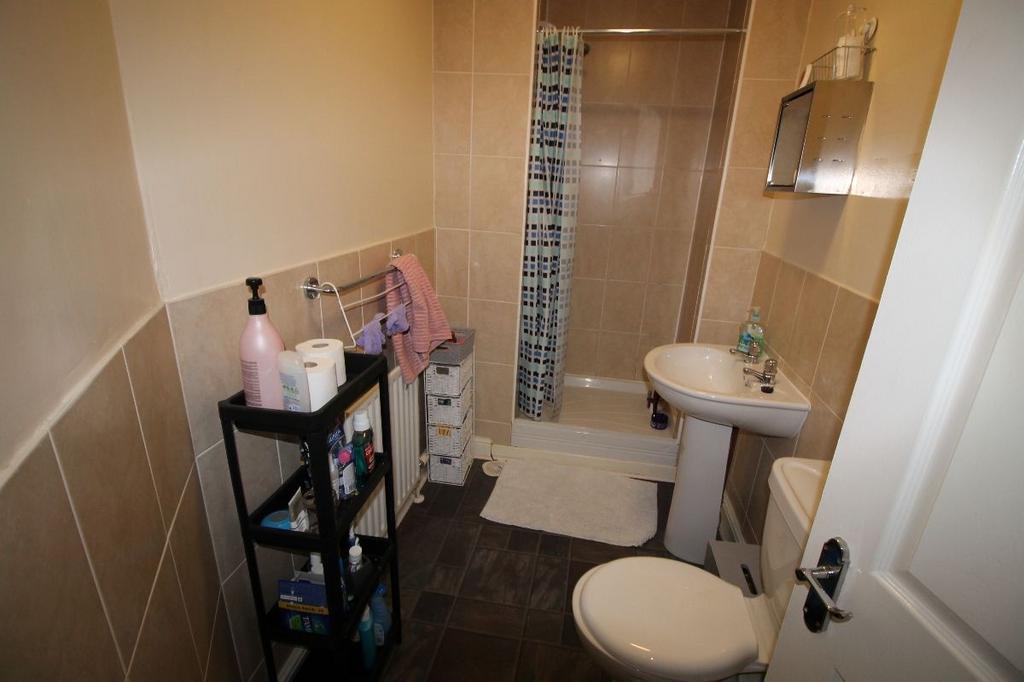 A tidy bathroom featuring a sink, toilet, and e...
