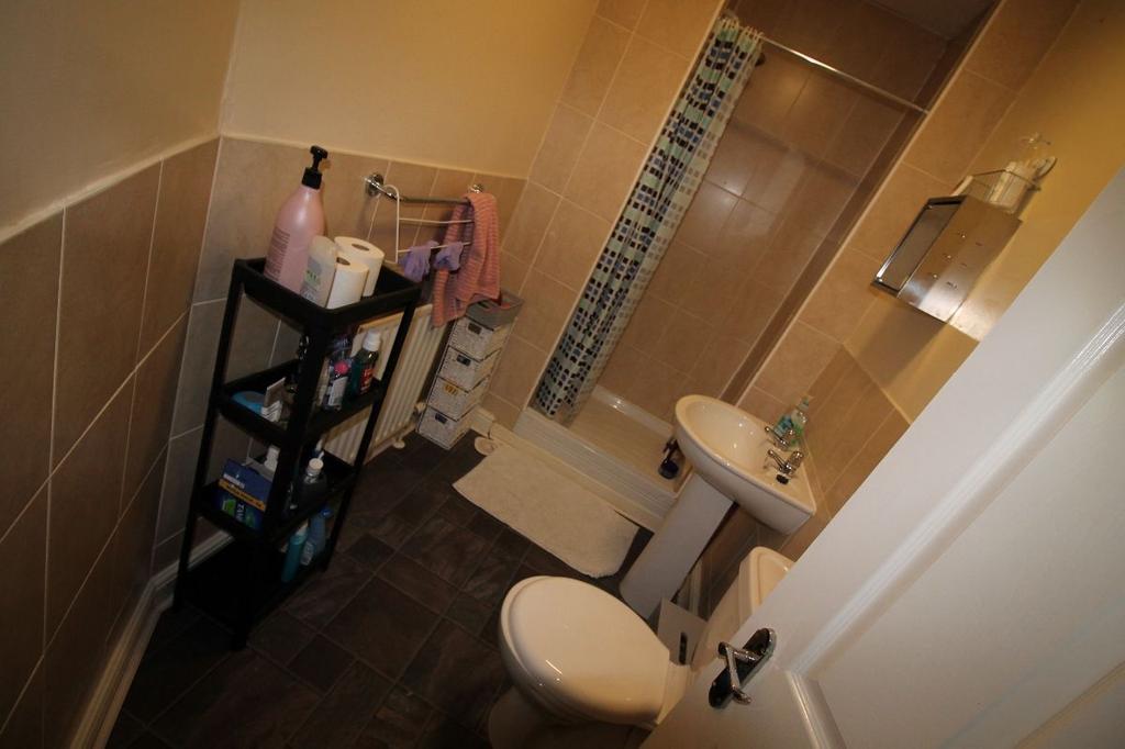A clean and functional bathroom with a large ba...