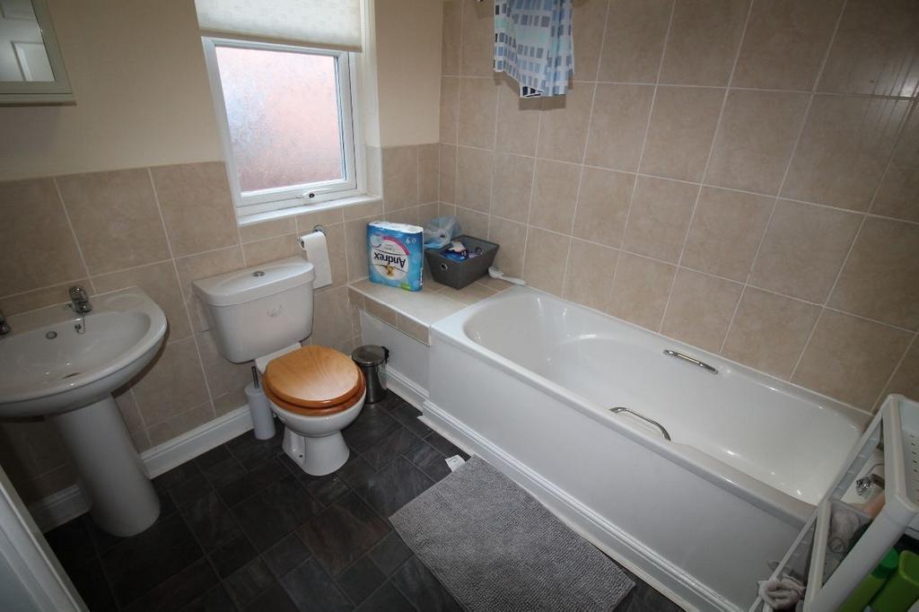 A clean and functional bathroom with a bathtub,...