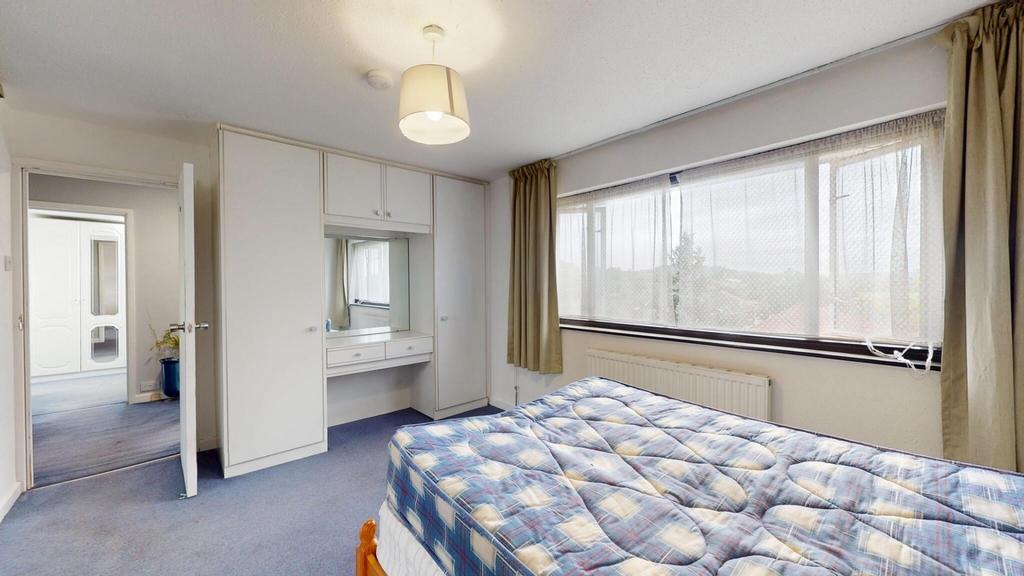 Spacious master bedroom featuring a large bed, ...