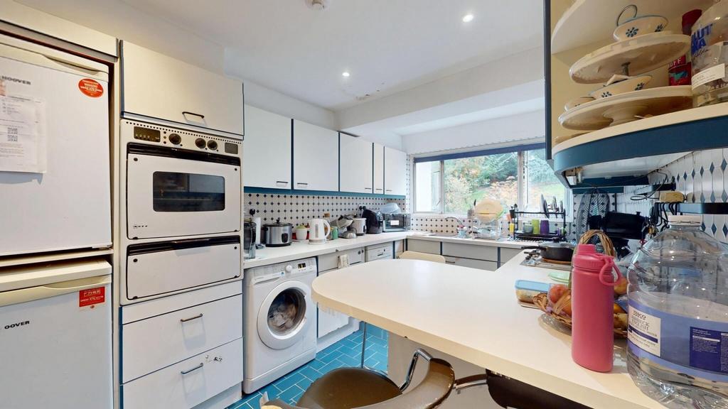 A bright and well-organized kitchen with ample ...