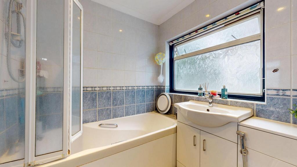 A spacious and well-maintained bathroom featuri...