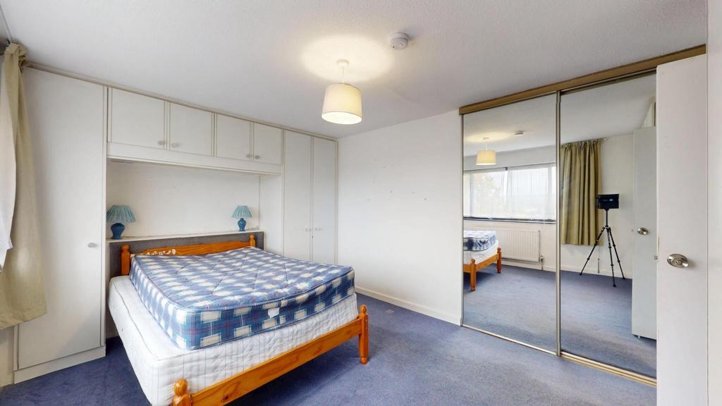 A well-lit double bedroom featuring a double be...