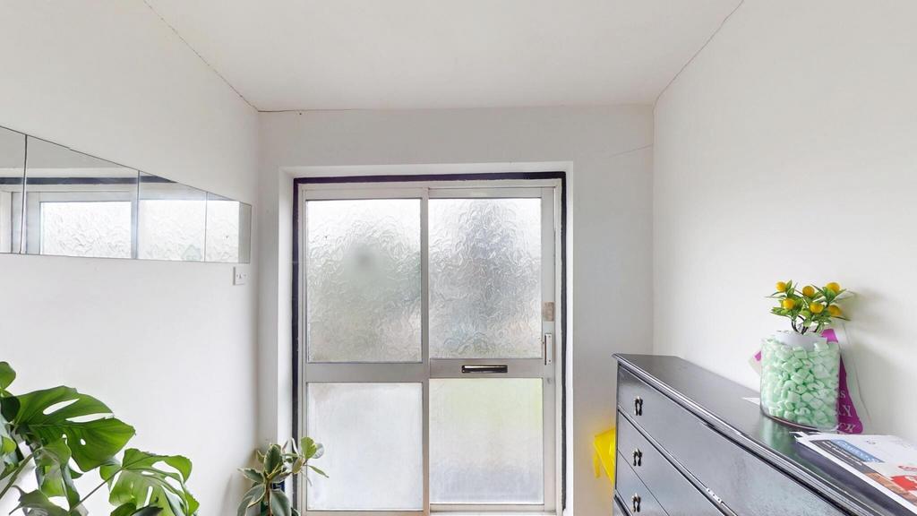 Bright and clean bedroom with a large window al...