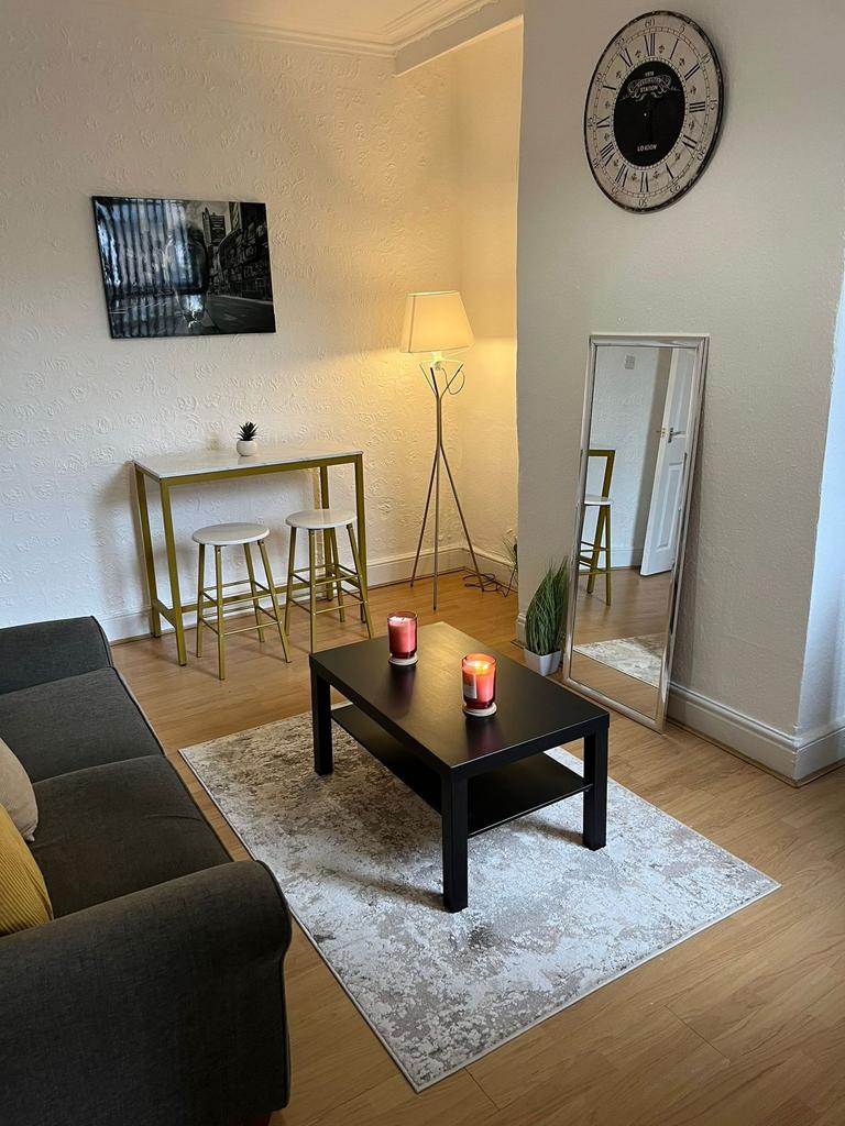 A bright and cozy living room featuring a comfo...