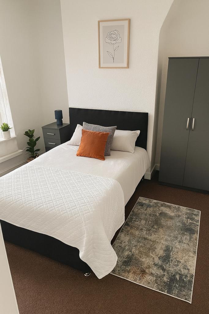 A cozy, well-maintained bedroom featuring a com...