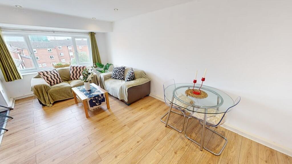 A bright and welcoming living room featuring a ...