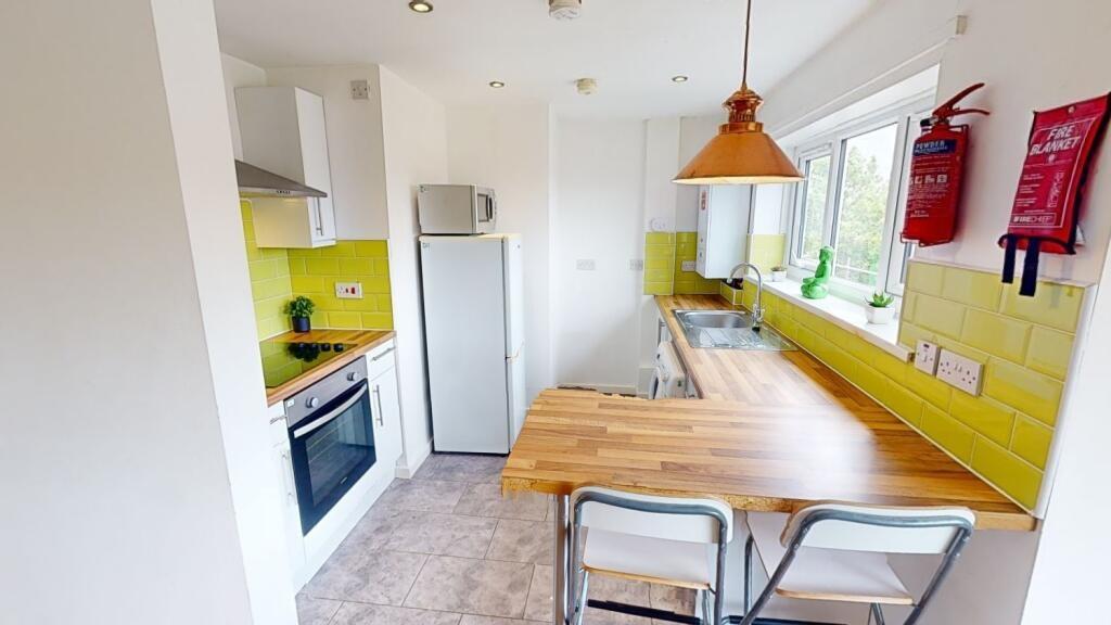 Bright and modern kitchen featuring a wooden di...