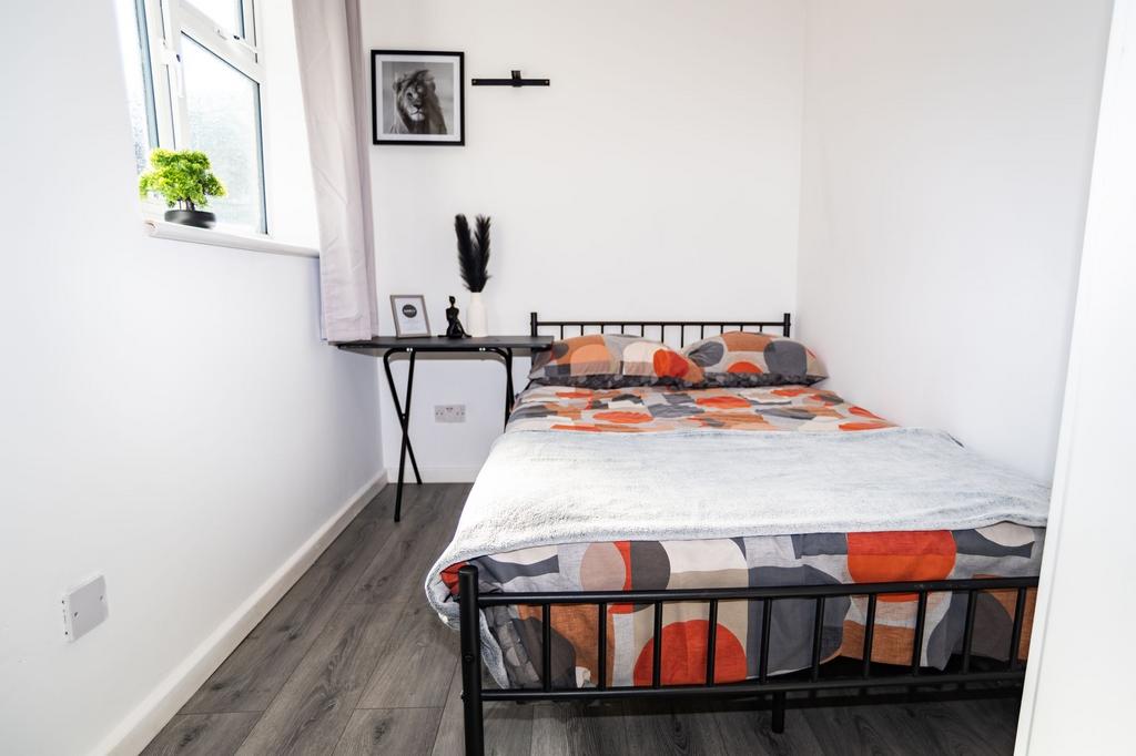 A well-lit, neatly maintained double bedroom fe...