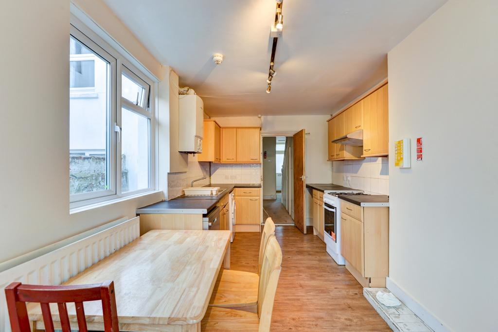 A bright and welcoming living room with ample n...
