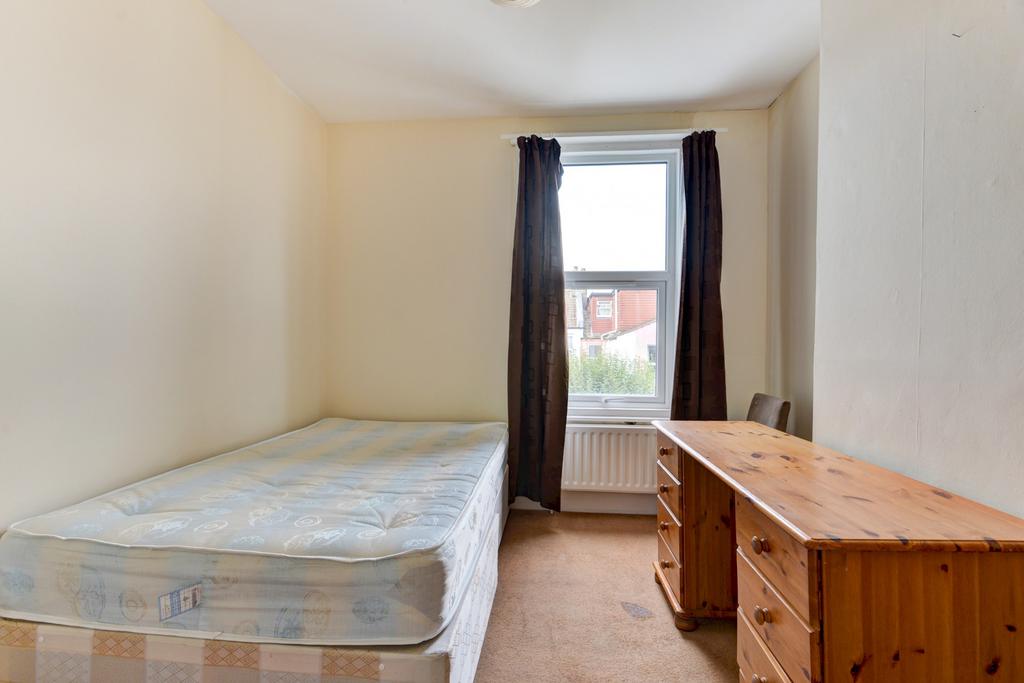 Simple, tidy bedroom with a bed by the window, ...