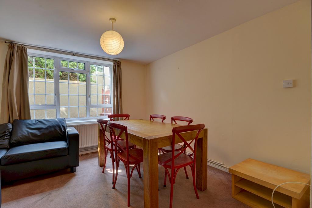 A well-lit living room featuring a comfortable ...