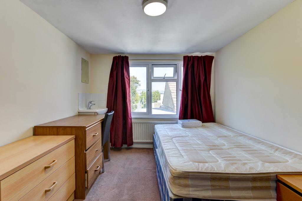 Bright, simply furnished double bedroom with a ...