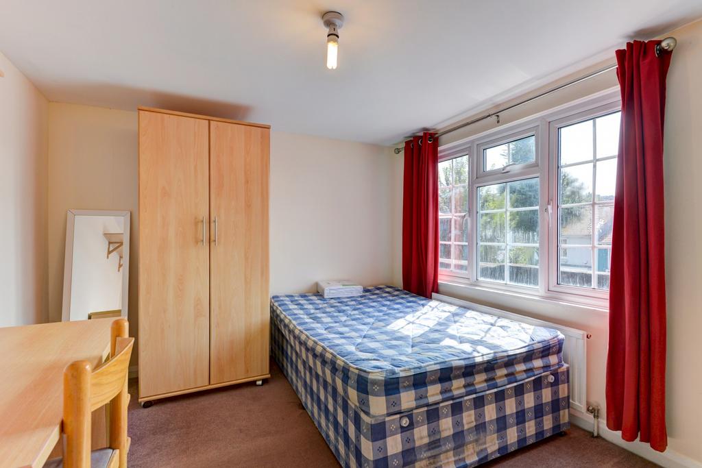 A tidy student bedroom with a single bed, a war...