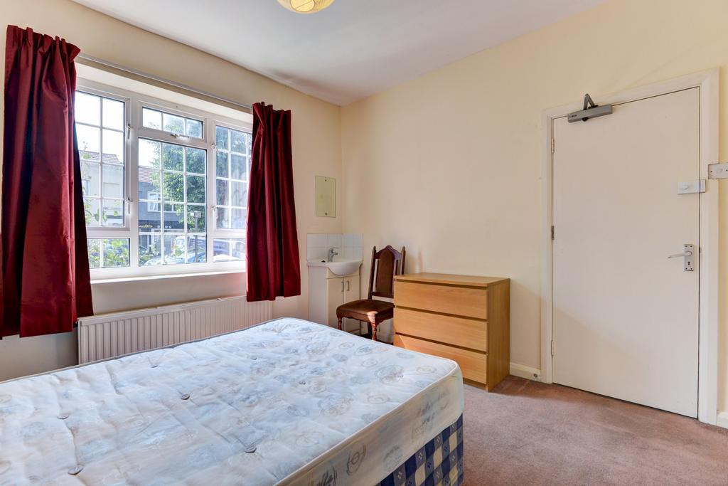 A cozy single bedroom featuring a large window ...