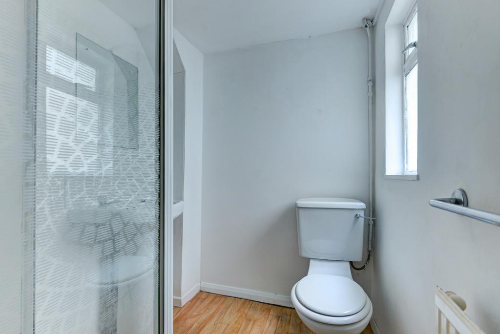 Bright and clean bathroom featuring a toilet wi...