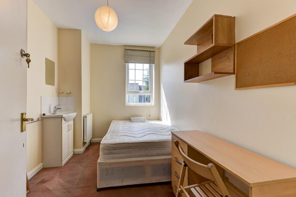 A cozy student bedroom featuring a clean, tidy ...
