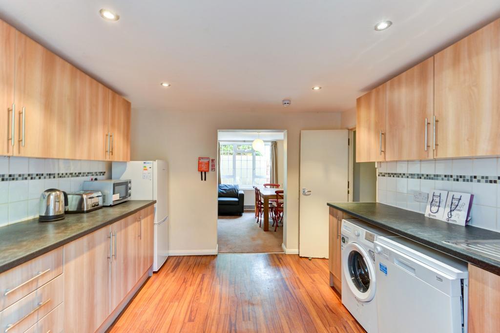Bright, modern galley kitchen with wood-effect ...