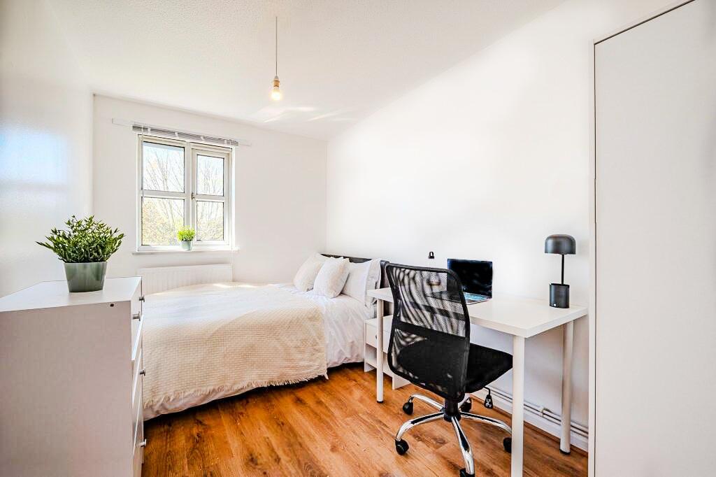 Bright and neatly maintained bedroom featuring ...