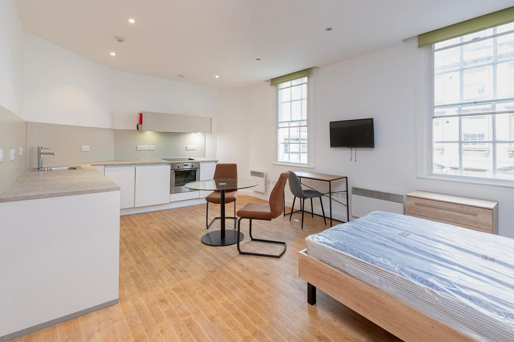 A bright and modern kitchenette with ample spac...