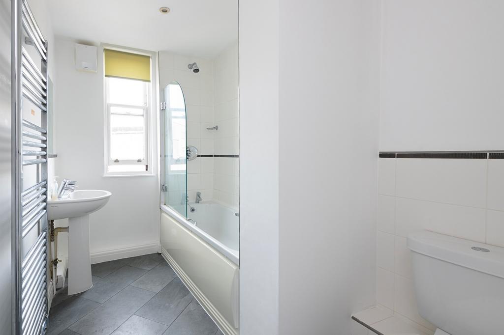 A spacious and bright large bathroom featuring ...