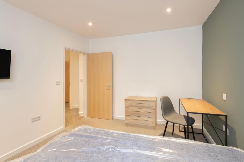 A bright and spacious double bedroom featuring ...
