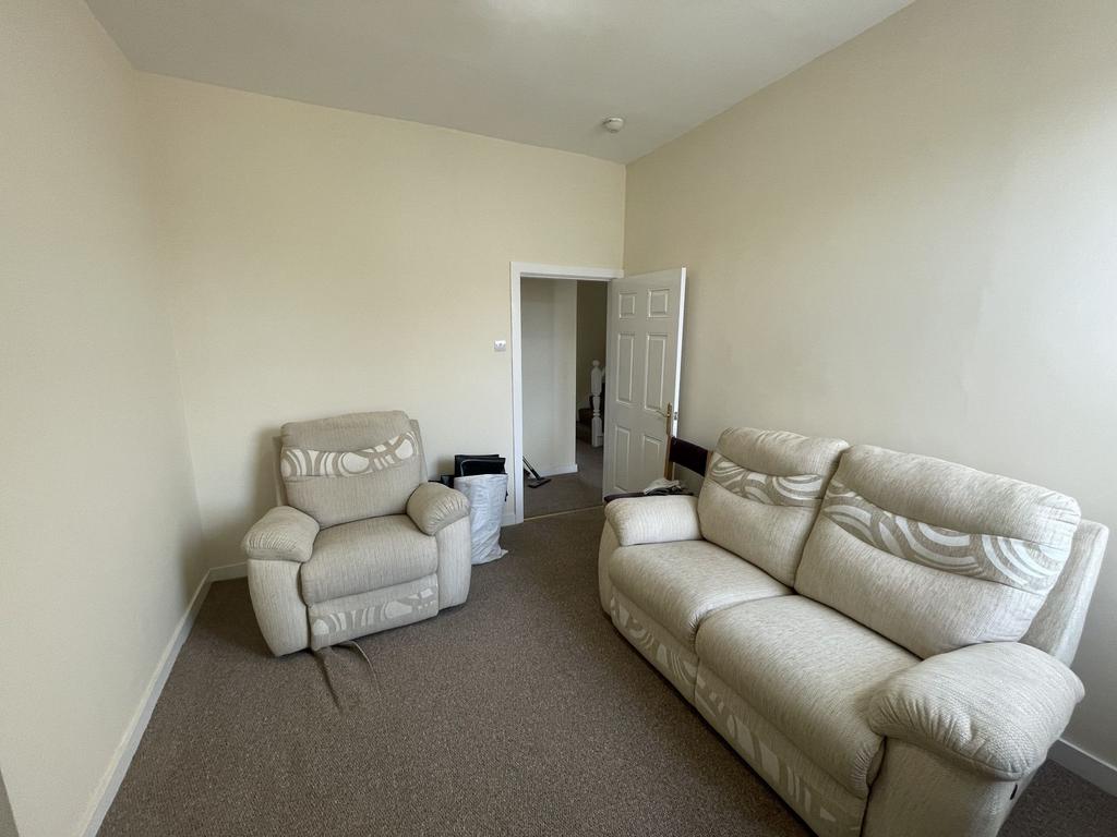 A bright and welcoming living room furnished wi...