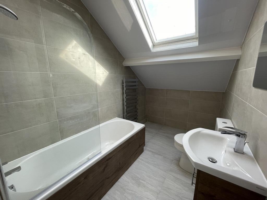 Bright and modern bathroom featuring a large ba...