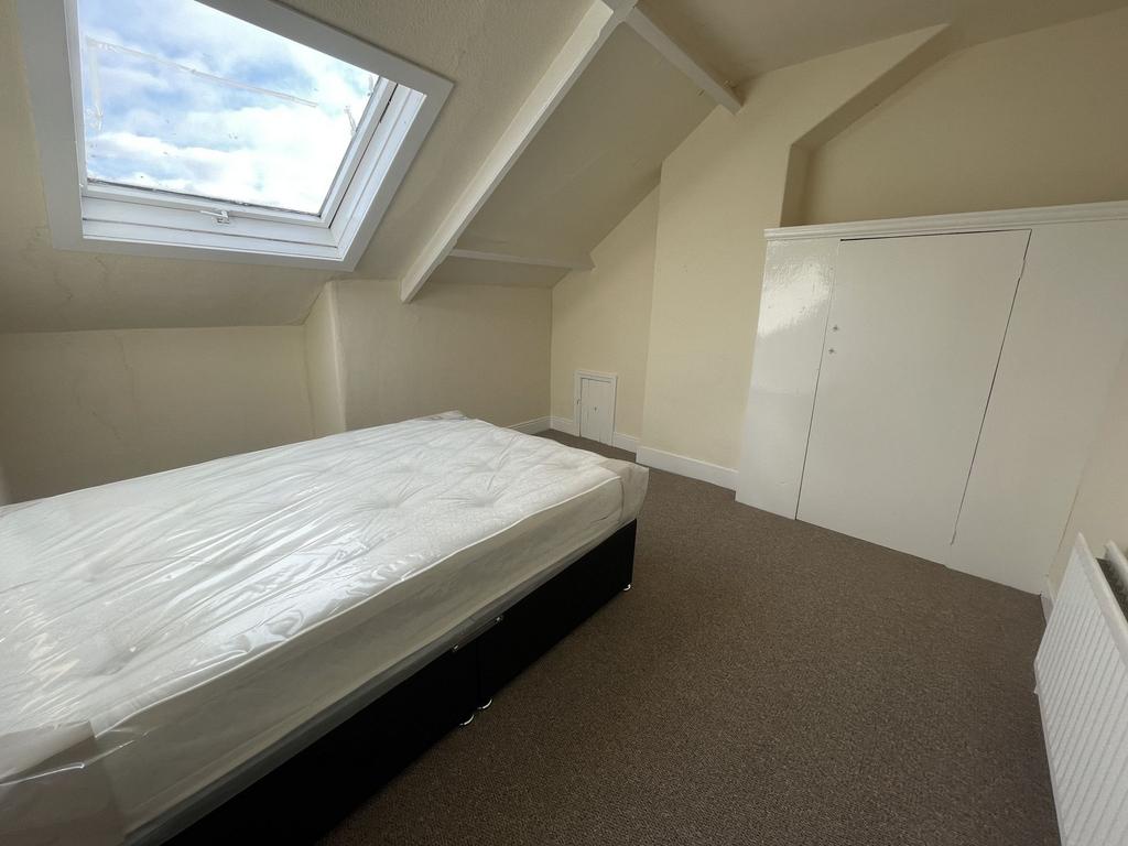 A spacious double bedroom with a large skylight...