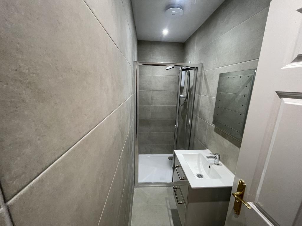 Modern bathroom featuring a walk-in shower with...