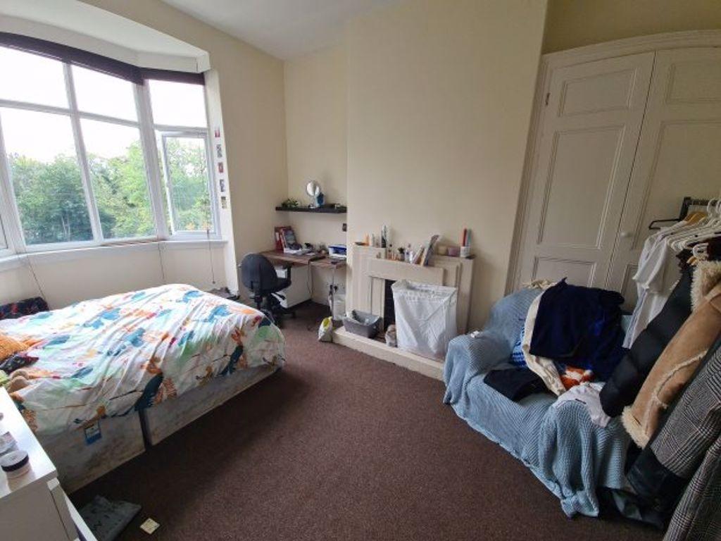A bright and welcoming double bedroom featuring...