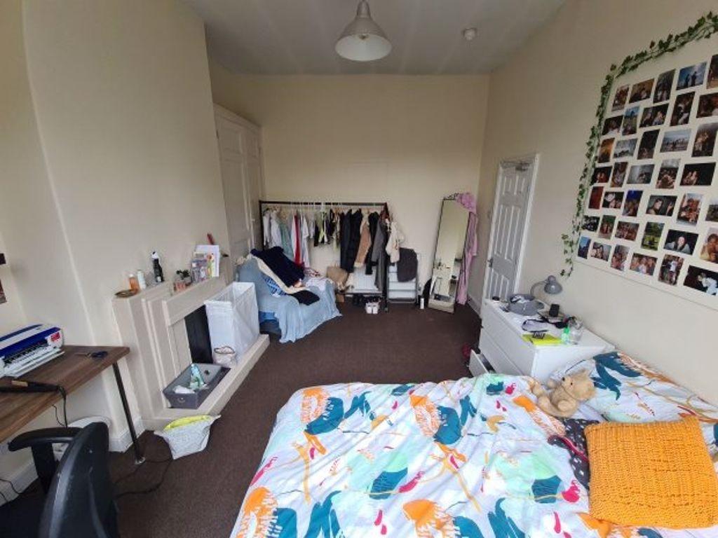 A bright and welcoming double bedroom featuring...