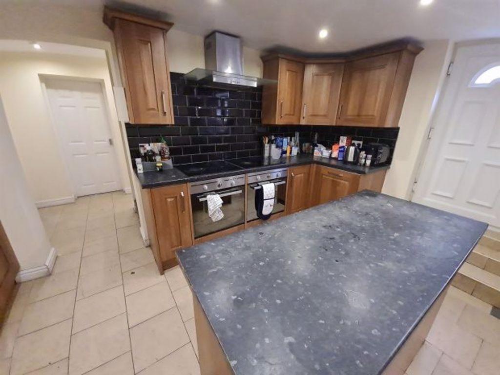 Spacious kitchen with ample wooden cabinetry, m...