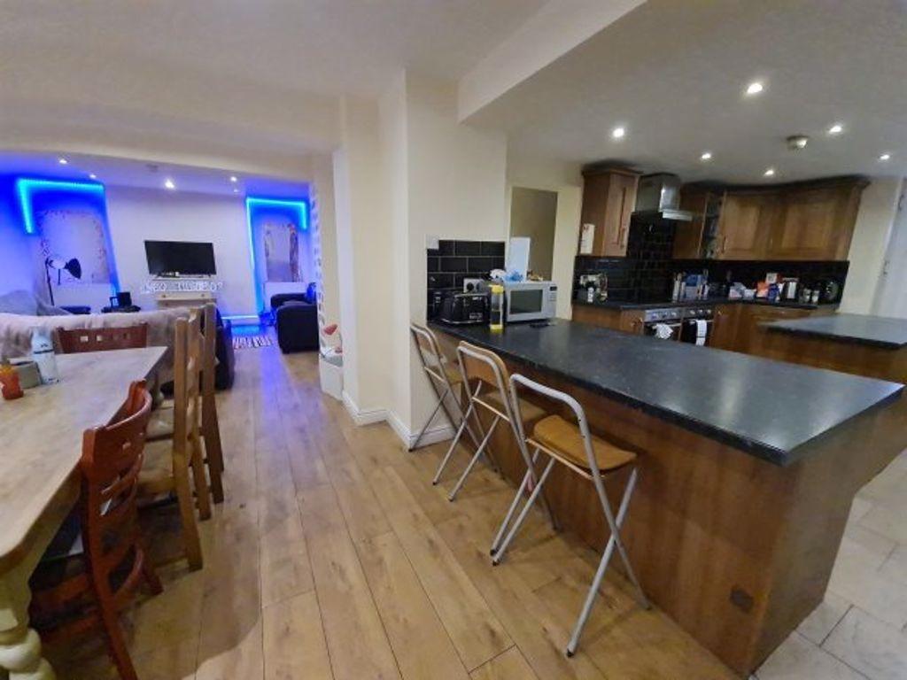 A spacious, modern kitchen featuring a large is...