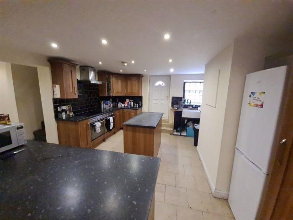 A modern kitchen featuring ample countertop spa...