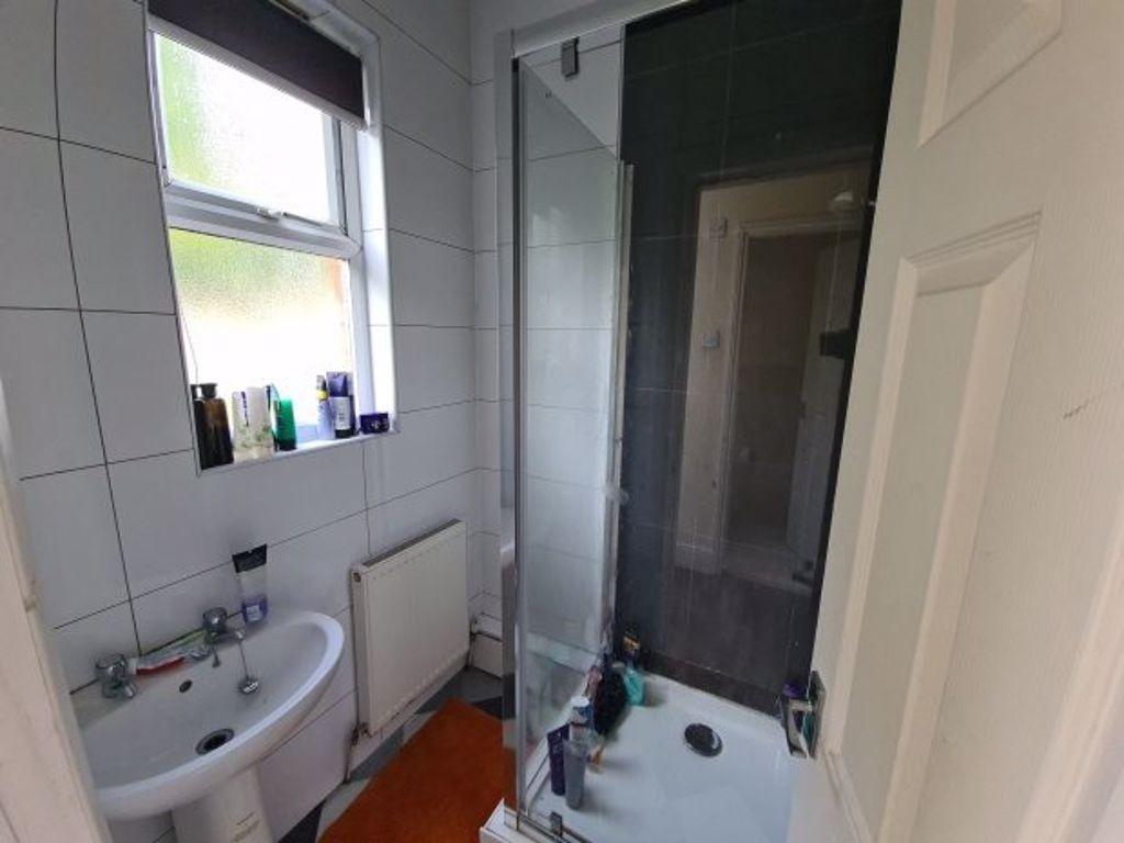 A modern bathroom featuring a clear glass showe...