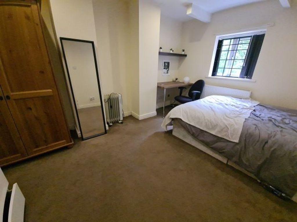 Cozy bedroom featuring a comfortable single bed...