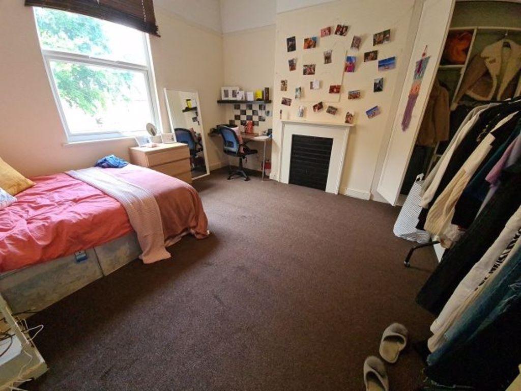Cozy single bedroom featuring a comfortable bed...