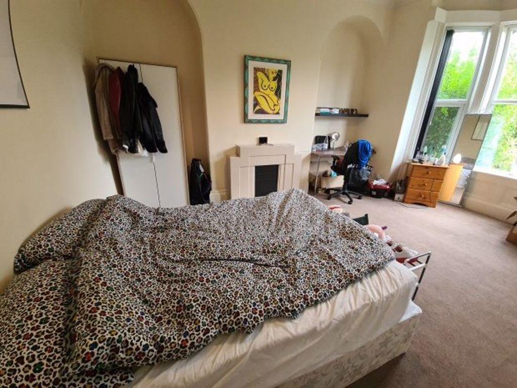 A spacious and bright master bedroom featuring ...