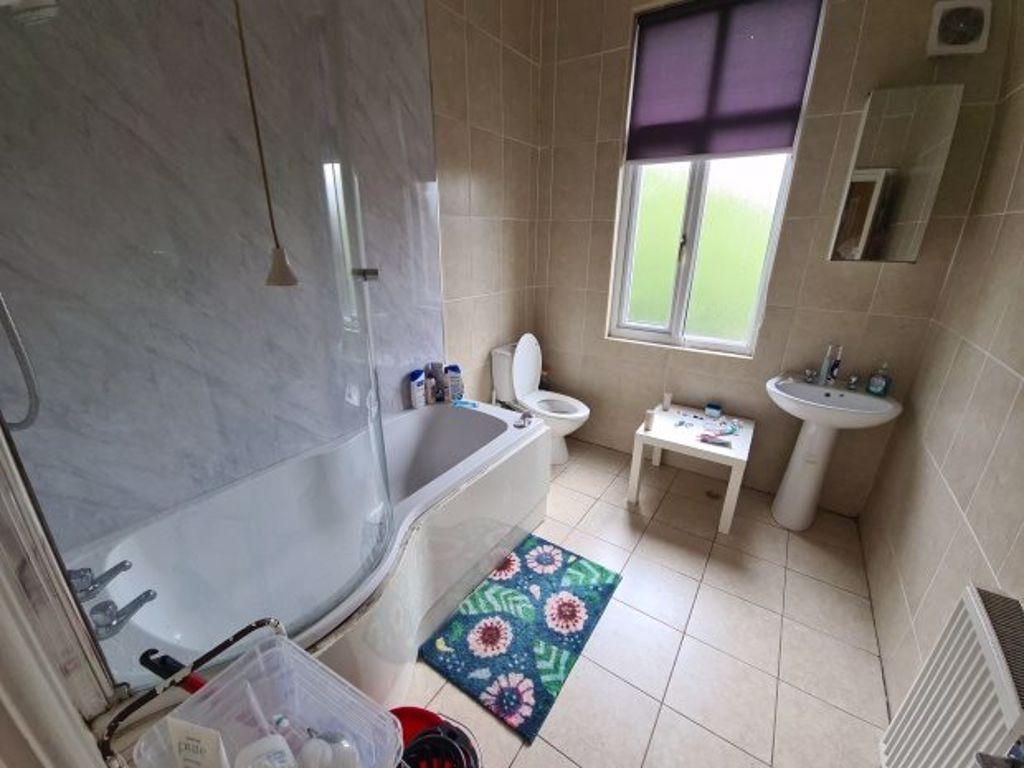 Bright and well-maintained bathroom featuring a...