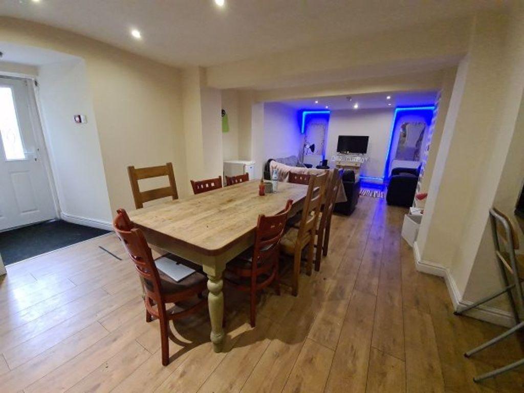 A spacious living and dining area featuring a l...