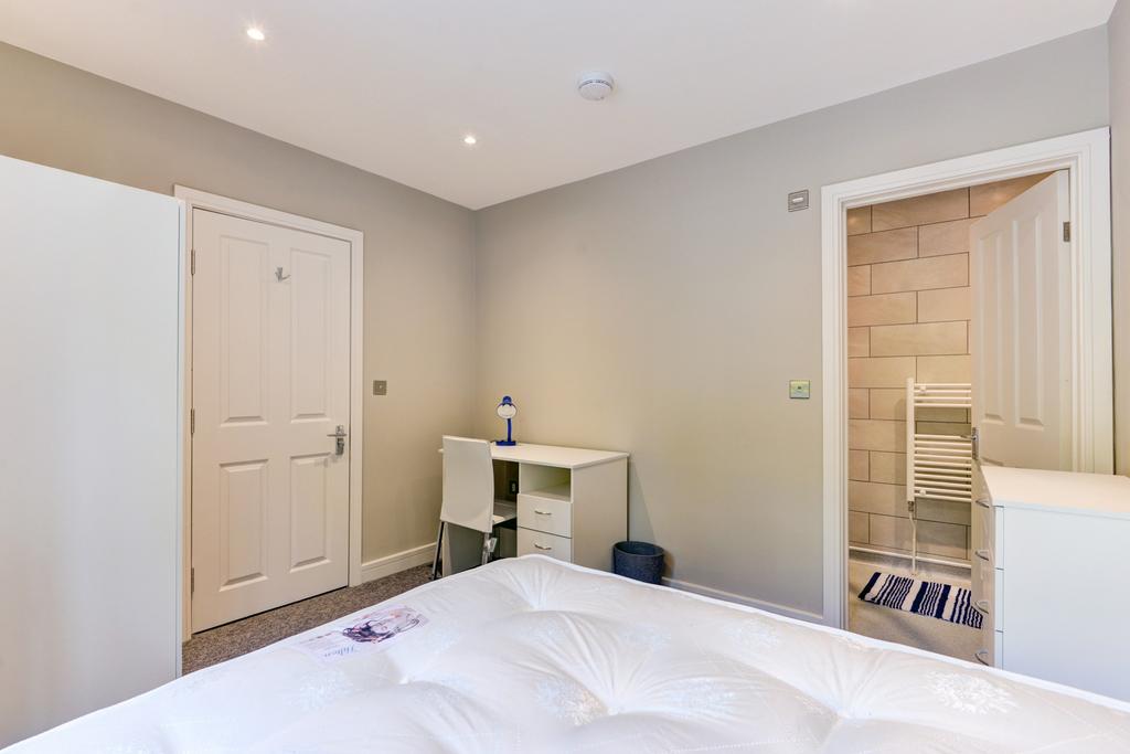 A bright and inviting double bedroom featuring ...