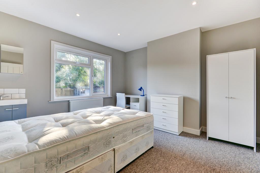 Bright and spacious master bedroom featuring a ...