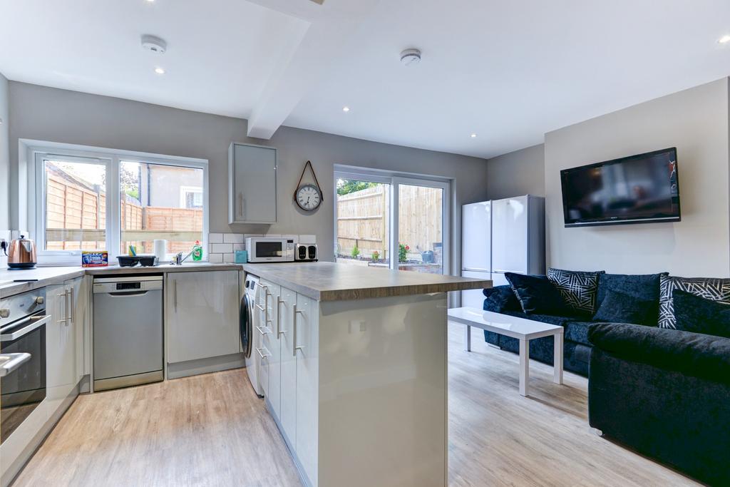 A bright and spacious living room featuring mod...