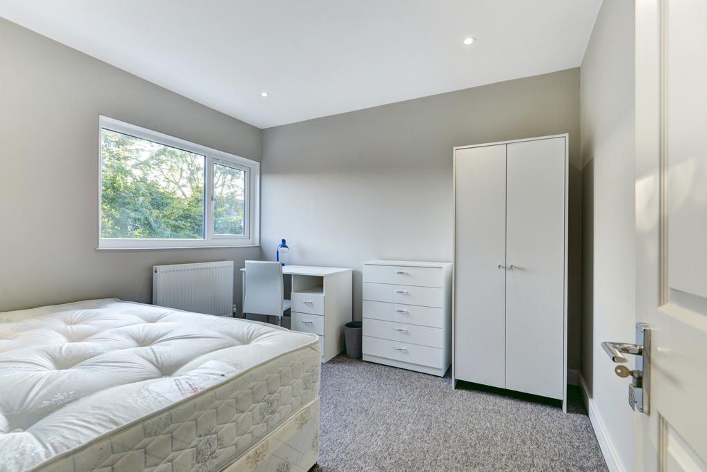 Bright and airy master bedroom with ample natur...