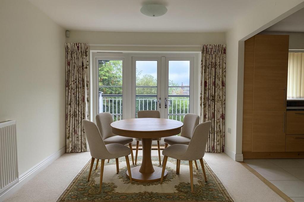 AI staged dining area next to kitchen + actual cur