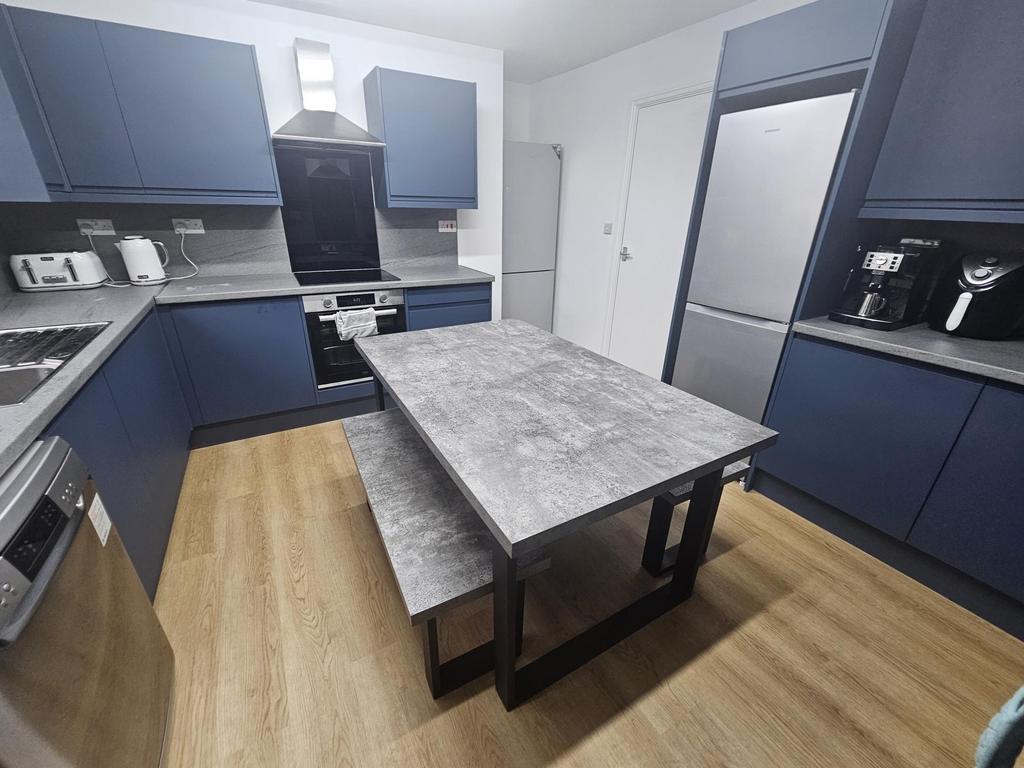 Modern and well-maintained kitchen with ample c...